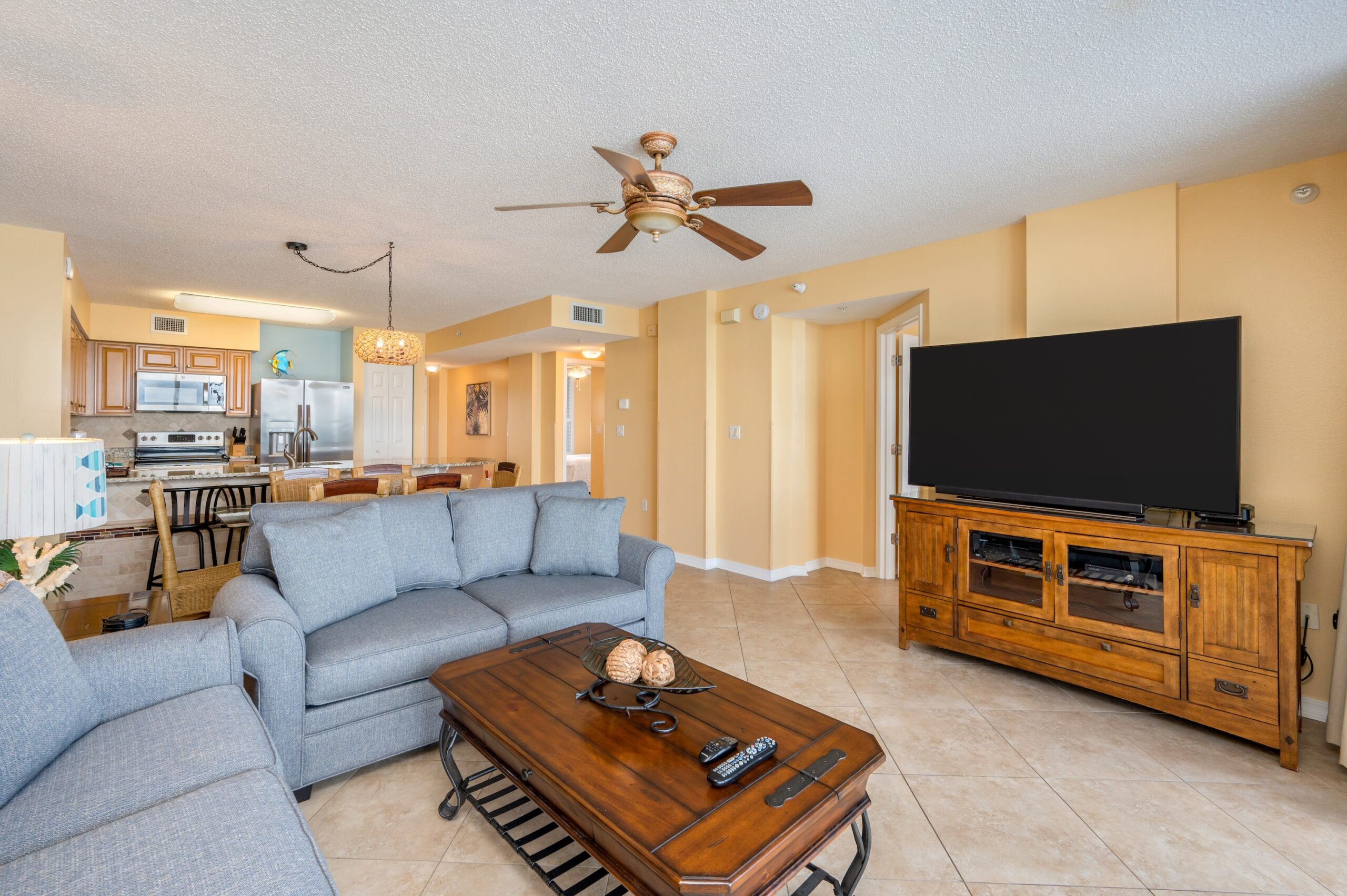 A large TV and console is in the beach condo's living room