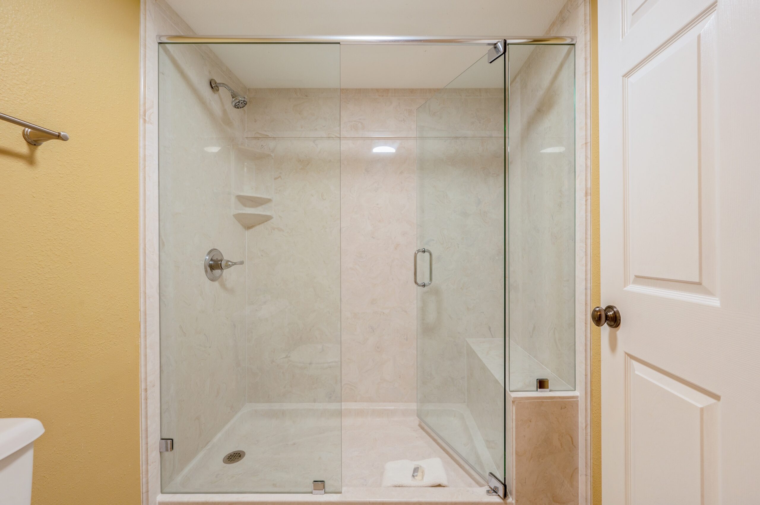 Updated master shower with large frameless glass door